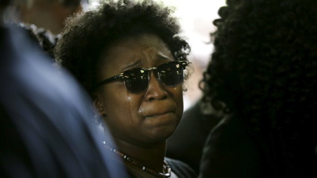 A family member weeps while entering the church for the funeral of Walter Scott.