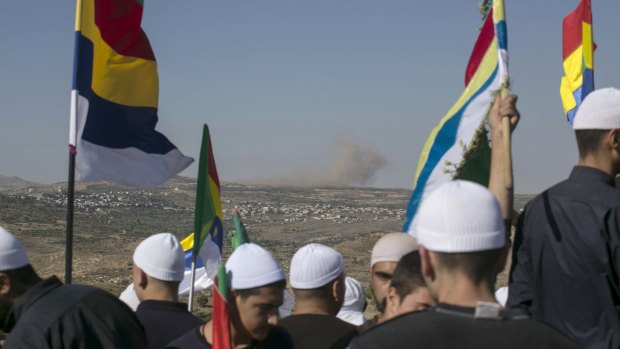 Druze in the Israeli-occupied Golan Heights watch fighting in the Syrian village of Khadr.  
