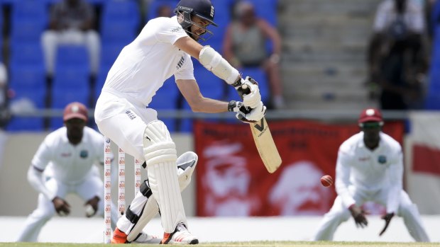 England's James Anderson hits a four off West Indies' Jason Holder.