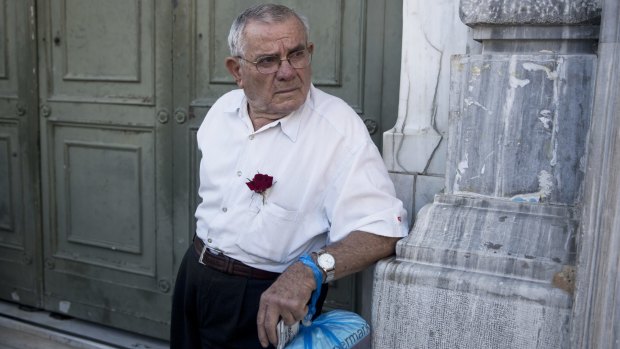 Grim future ... A pensioner stands outside the main gate of the national bank of Greece as he waits to withdraw a maximum of 120 euros ($134) for the week in Athens, on Tuesday.