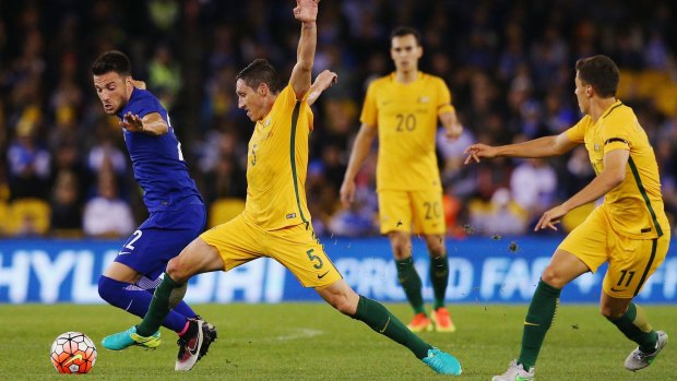 Andreas Samaris of Greece and Mark Milligan of the Socceroos compete for the ball during the friendly at Etihad Stadium on Tuesday night.