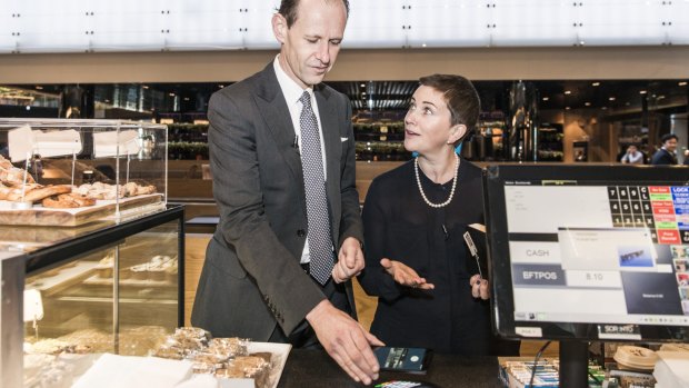 ANZ Bank chief executive Shayne Elliott tries out Android Pay, alongside general manager of deposits and payments, Katherine Bray.