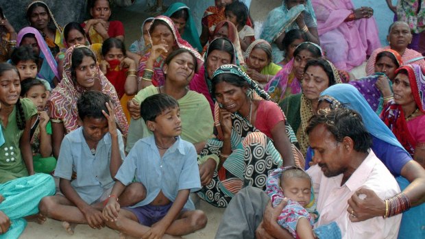 Tears: Relatives mourn for women who died after undergoing sterilisation surgery.