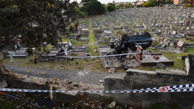 The car ploughed through a sandstone wall into Randwick Cemetery.