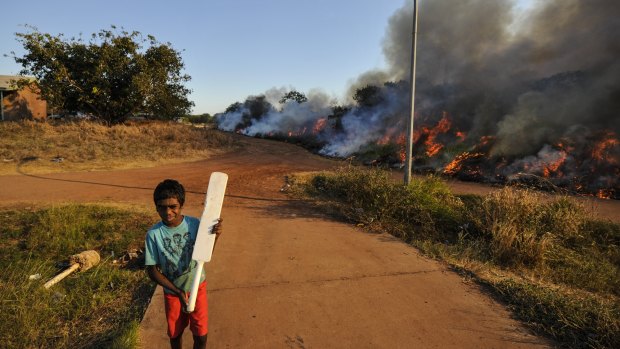 A cricket game is interrupted as fire takes over Minmarama Park community in Darwin, Northern Territory.