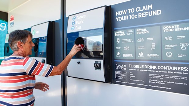 Una Bell loads a can into a 'Return and earn" recycling machine in Gladesville this month.