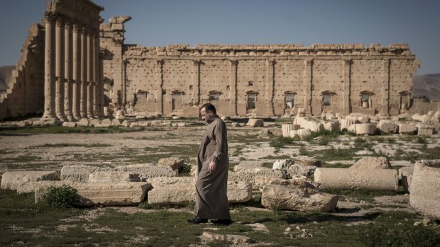 A man walks through the ruins of the Temple of Bel in Palmyra, Syria, last year. 