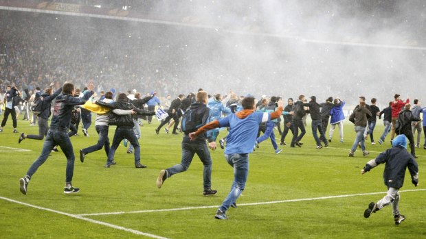 Dnipro Dnipropetrovsk's supporters run onto the pitch to celebrate the victory over Napoli in the Europa League semi-final.