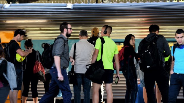 Commuters wait for the train at Strathfield station on Monday.