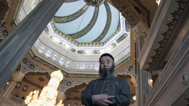 A believer prays inside the newly restored Moscow The Cathedral Mosque in Moscow on Wednesday.