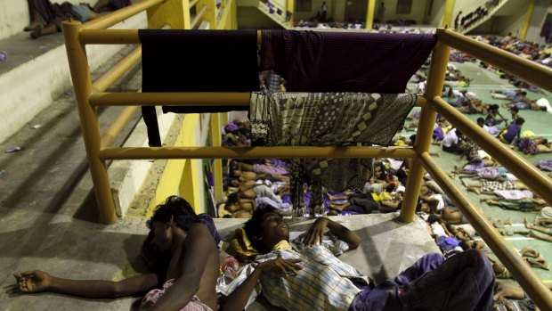 Migrants believed to be Rohingya rest inside a shelter after being rescued by fishermen at Lhoksukon in Indonesia's Aceh Province on Monday.