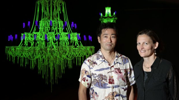  Artists Ken and Julia Yonetani stand in front of their work USA 2013 a chandelier made from uranium glass. 