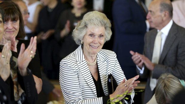 Daphne Benaud applauds after a speech by Jeffrey Benaud at Richie Benaud's wake at the Australian Golf Club.