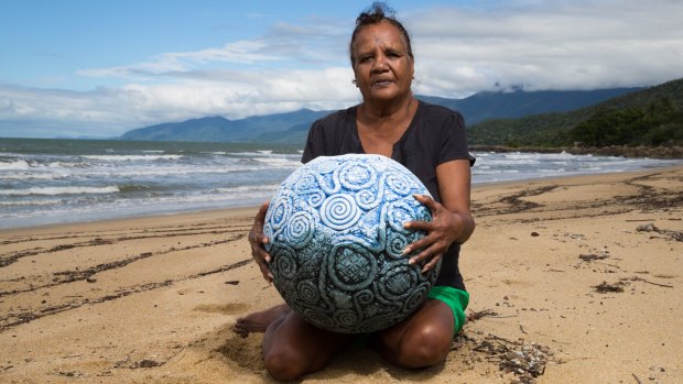 Yarrabah artist Michelle Yeatman with one of her pots with its distinctive coil patterns inspired by the shells she collects on the beach. 