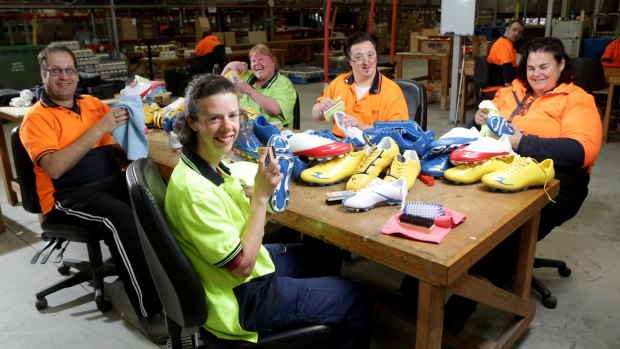 Just like new: (From left) Chris, Olivia, Loanne, Danny and Kim clean up donated footy boots.
