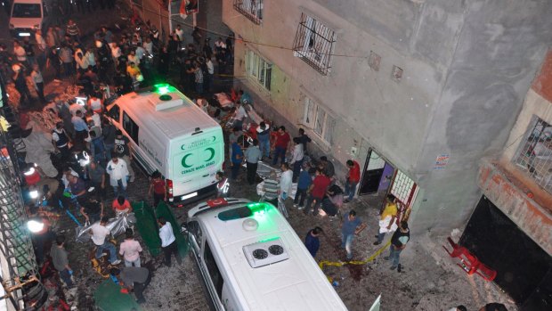 People carry dead bodies into ambulances after the explosion that left dozens dead. 