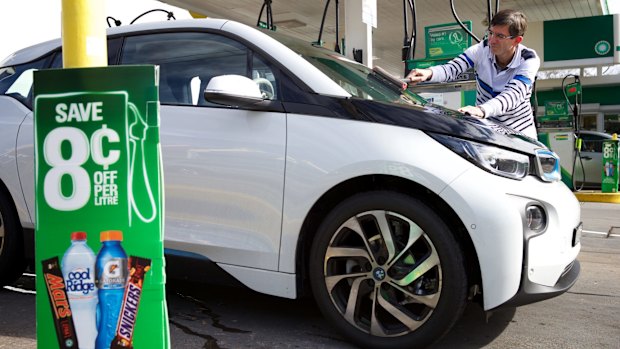 One thing service stations are good for: cleaning electric car windscreens. The author is pictured with a fully electric BMW i3.