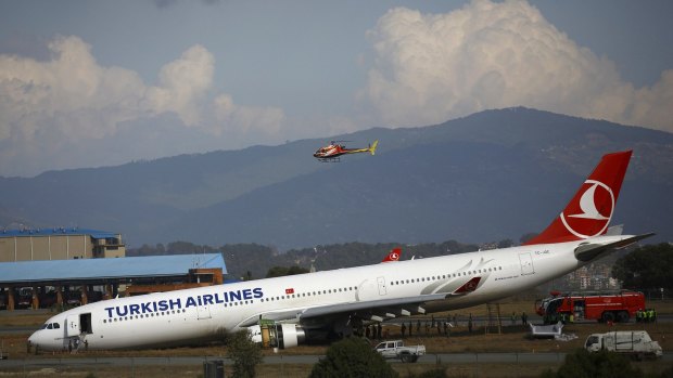 Nose down: TheTurkish Airlines Airbus A330 lies on a field after it overshot the runway at Tribhuvan International Airport in Kathmandu.