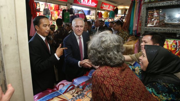 Malcolm Turnbull with Indonesian president Joko Widodo in Jakarta during a stroll through a local textile markets.