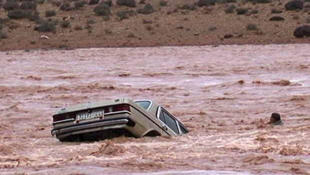 A driver and his car are washed away by flood waters in Ouarzazate, Morocco.