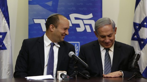 Israeli Prime Minister Benjamin Netanyahu (right) smiles with HaBayit HaYehudi leader Naftali Bennett at the Knesset in Jerusalem after announcing the 11th-hour formation of a coalition government.