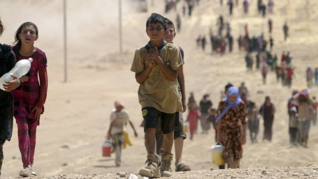 Survival first, schooling second ... Children from the minority Yazidi sect flee Islamic State militants in Sinjar, Iraq in 2014.
