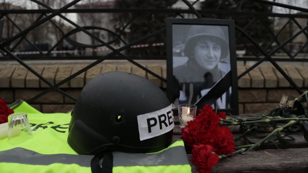 Portrait of killed Russian journalist Anton Voloshin, with flowers, outside the court in Donetsk on Tuesday. 