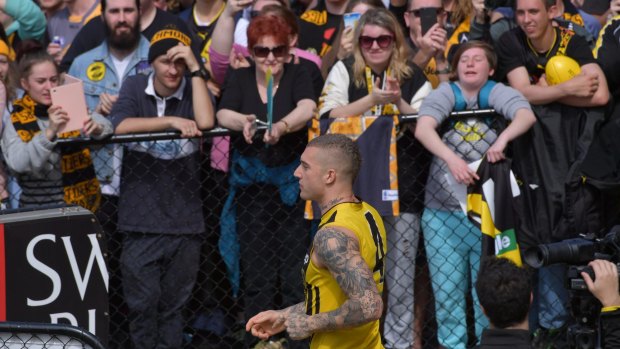 Fans watch Dustin Martin at training.