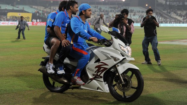 Out of gas: Motorbike aficionado Dhoni gives Praveen Kumar a lift after an ODI against England in 2011.