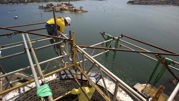 Over three months into the restoration of Cockatoo Island's power station chimney, Travis Reynolds and Rhys McCormack assess brickwork on its upper section. 