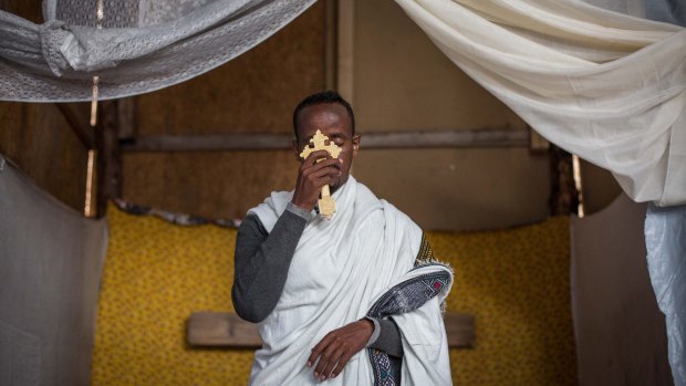 Kibrom Kasta leads an Orthodox service for Ethiopian and Eritrean worshippers at a makeshift church in Calais, France on Sunday.