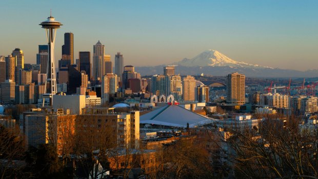 Seattle skyline at sunset with the Space Needle, downtown and Mount Rainier.