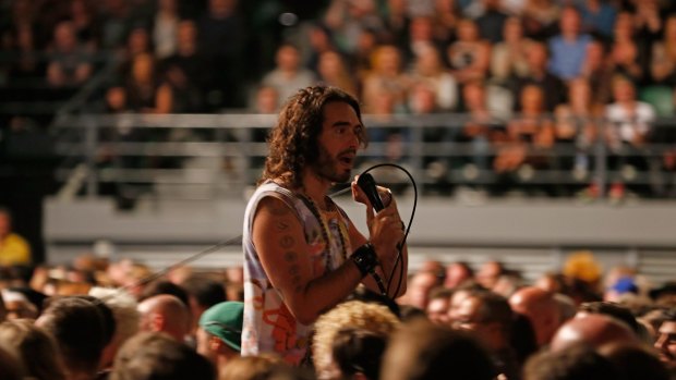 British comedian, writer and activist Russell Brand joins the crowd at Rod Laver Arena on the first date of his Trew World Order Australian tour.