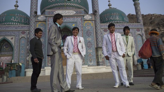Hazara youths accompany one of their friends to his wedding in Kabul. Both Islamic State and the Taliban have made the Shiite Hazaras their targets.