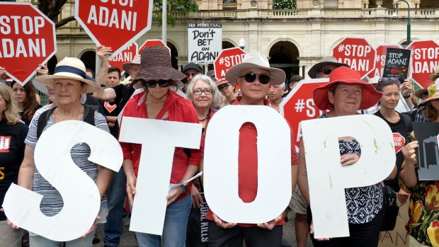 Adani protestors are seen protesting outside of Queensland's Parliament House in Brisbane.