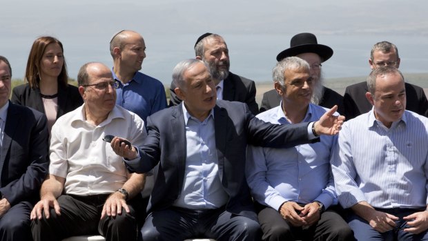 Israeli Prime Minister Benjamin Netanyahu, centre, poses with his ministers on the Israeli-occupied Golan Heights on Sunday. 