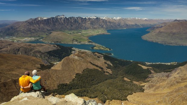 Hikers on the summit of Ben Lomond, looking over Queenstown and Lake Wakatipu.
