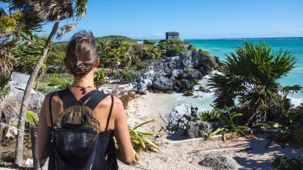 A woman takes in the view of El Castillo and the Caribbean coast at the Mayan site of Tulum. 