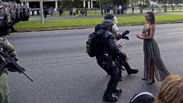 Making a stand: Police officers in riot gear face Ieshia Evans during a protest in Baton Rouge.