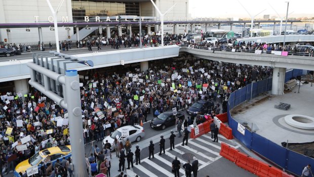 Demonstrators gather the LAX during a protest against President Donald Trump's travel ban on refugees and citizens of seven Muslim-majority nations, on Sunday.