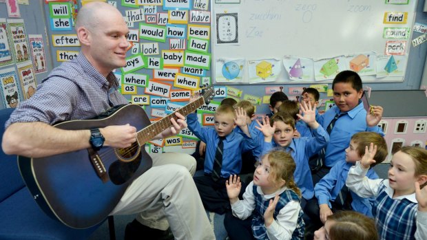 Rocking on: Dan Colquhoun whose songs are a big hit on YouTube, gets students into the swing of things at St Declan's Catholic Primary School. 