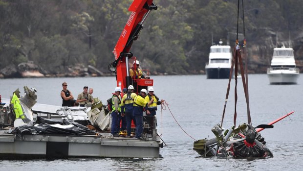 NSW police and salvage personnel work to recover the wreckage of a seaplane that crashed into Jerusalem Bay.