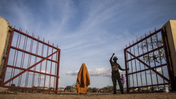 A police officer closes the gate between Bulo Hawa, Somalia, and Mandera, Kenya.