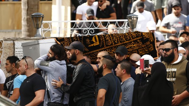Relatives and friends of Safwan Charbaji, who was shot dead in Condell Park, carry his coffin outside Lakemba Mosque.