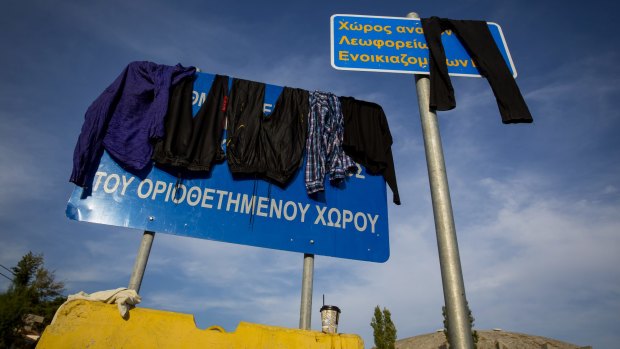 Refugees dry their clothes at the port of Mytilini in Lesbos, Greece, on Wednesday.
