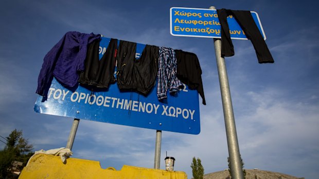 Refugees dry their clothes at the port of Mytilini in Lesbos, Greece, on Wednesday.