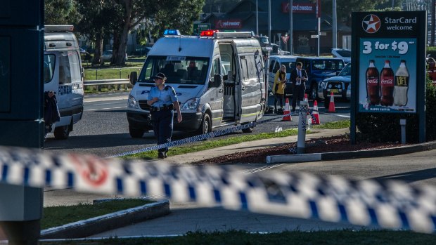 Police and emergency services at the scene of the Queanbeyan service station stabbing. 