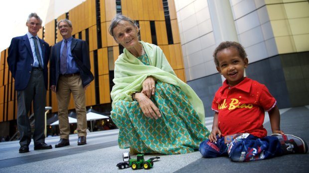 Australian nurse Valerie Browning in Sydney this week with her two-year-old adopted son Nabil. Looking on are her brothers David and George Browning.
