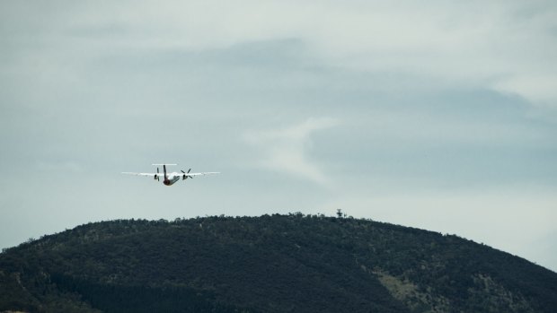 A plane departs Canberra, viewed from the airport tower.
