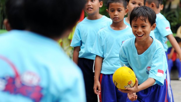 Students play Aussie Rules at an elementary school in Jakarta.